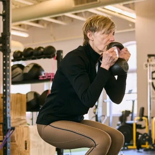 Woman holding kettlebell at Her Strength Studio