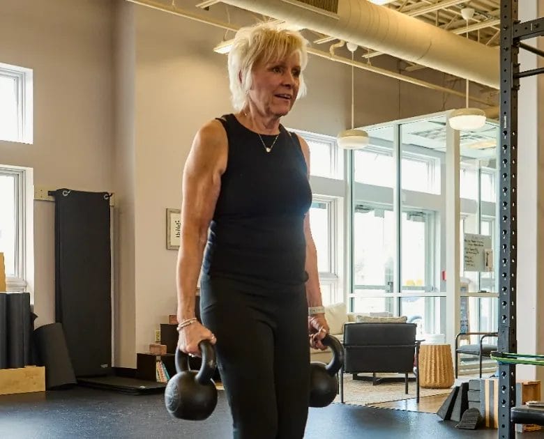 Woman with kettlebells at Her Strength Studio